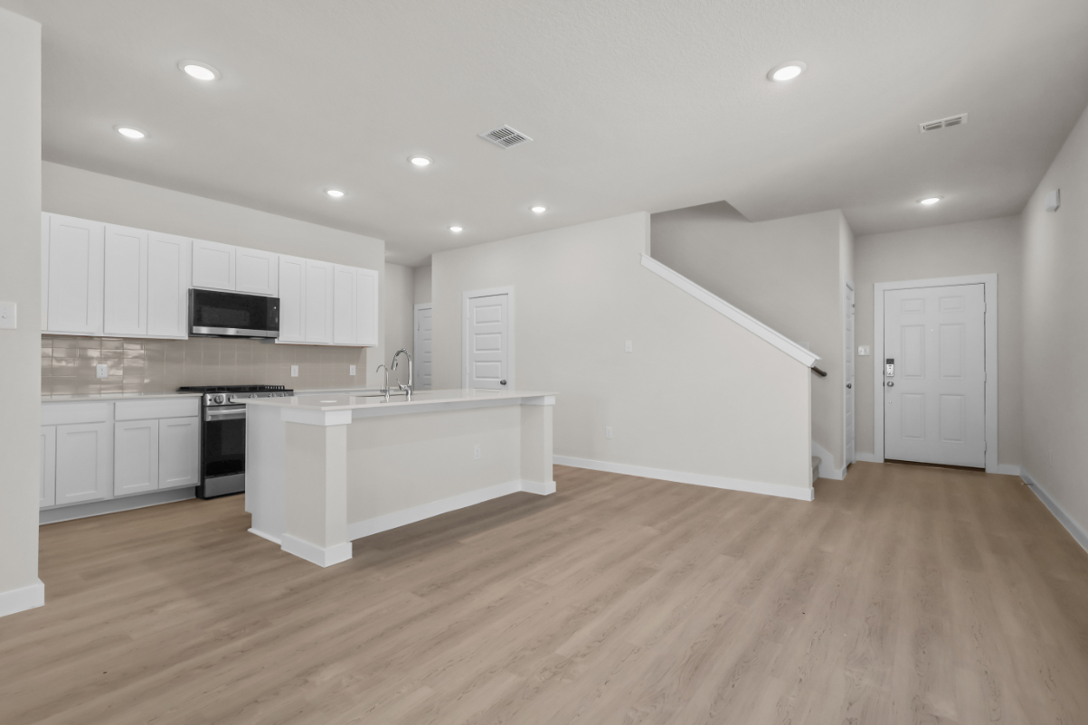 A kitchen with white cabinets.