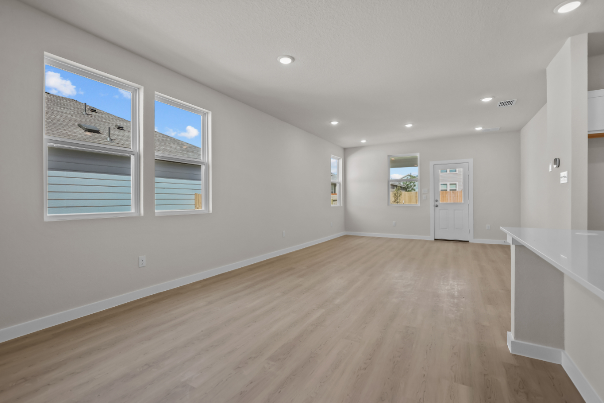 A room with a wood floor and white walls.