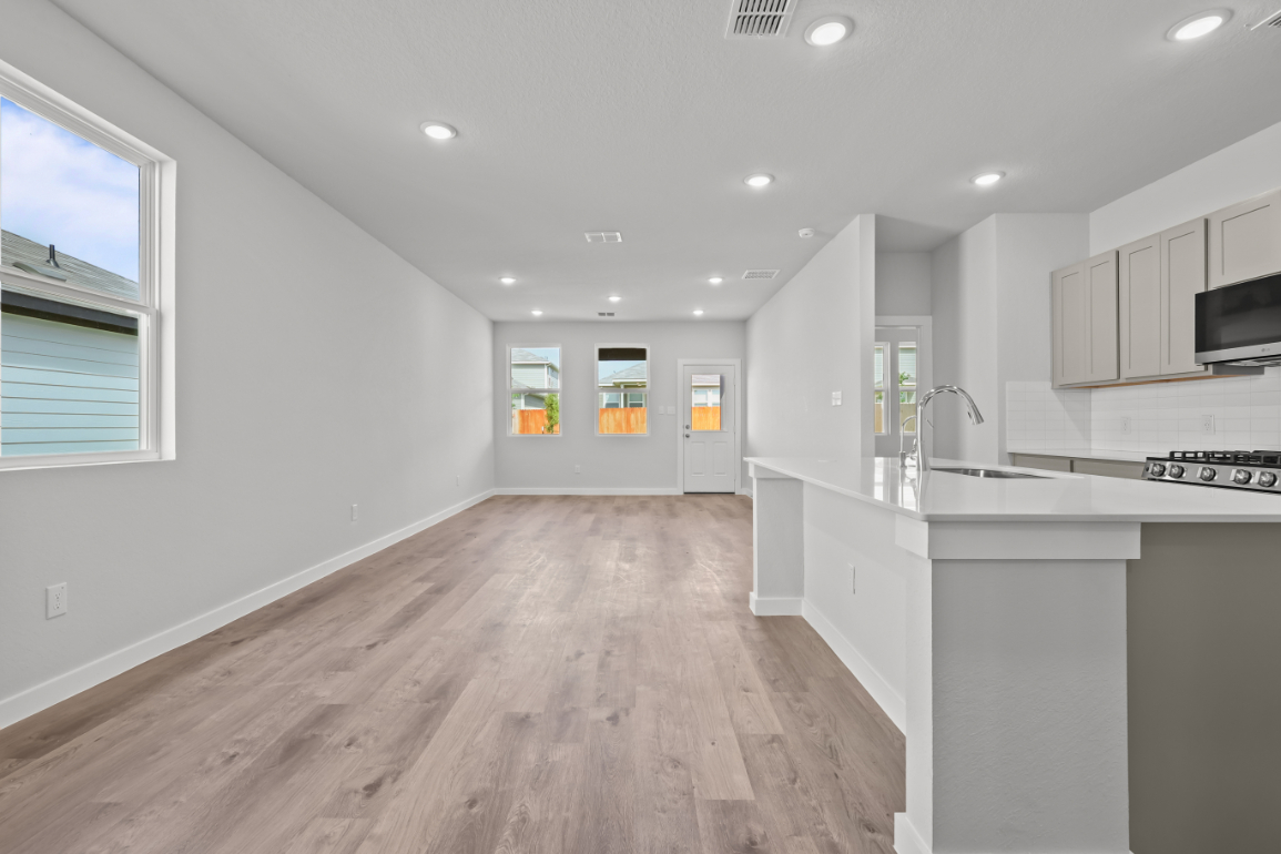 A kitchen with white cabinets.
