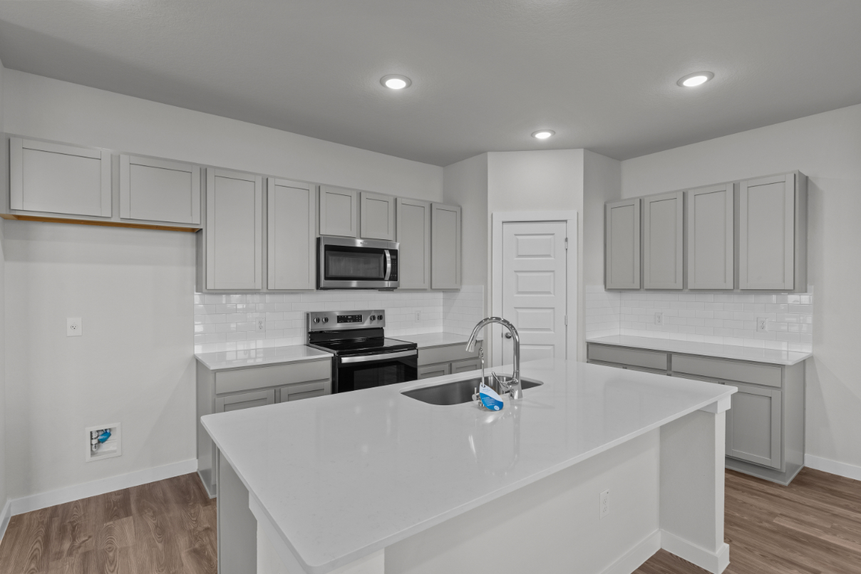 A kitchen with white cabinets.