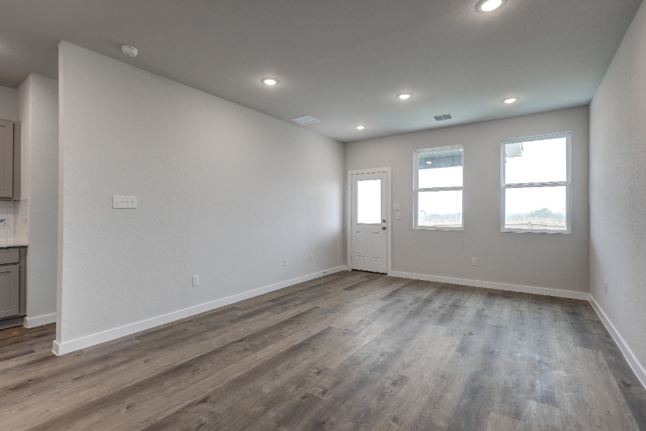 A room with a wood floor and white walls.