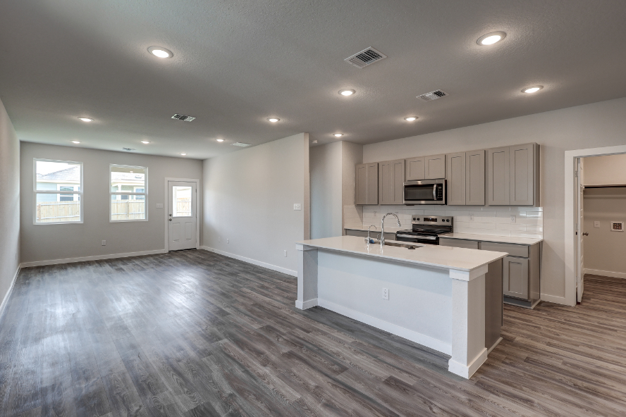 A kitchen with white cabinets.