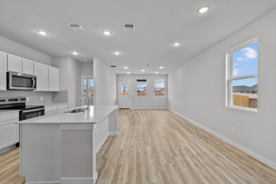 A kitchen with white cabinets.
