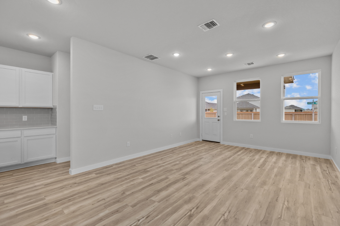 A room with white walls and a wood floor.