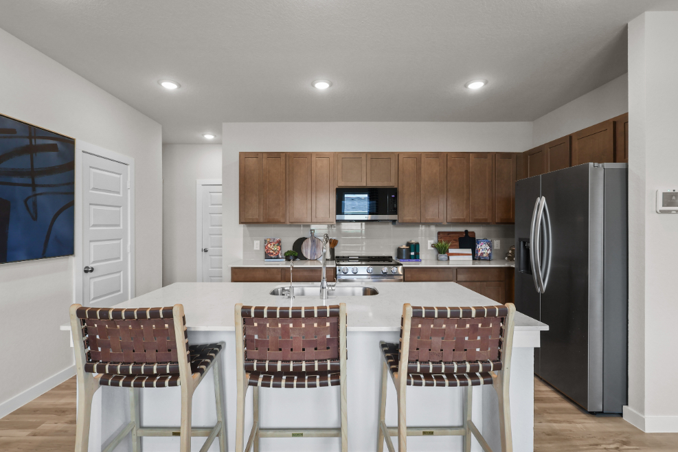 A kitchen with a table and chairs.