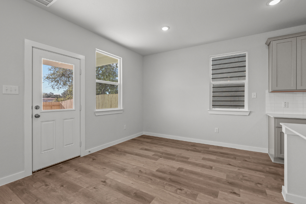 A room with a wood floor and white walls.