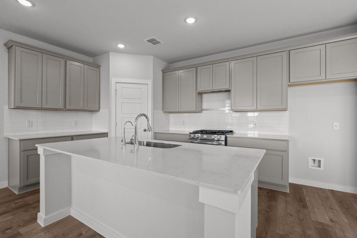 A kitchen with white cabinets.