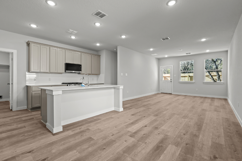 A kitchen with white cabinets.