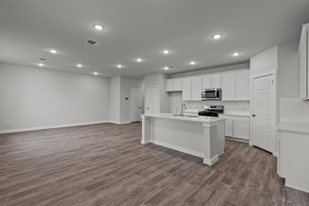 A kitchen with white cabinets.