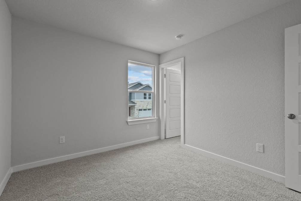 A room with a window and a door.