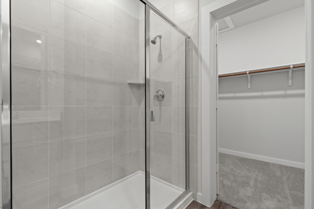 A shower with a glass door.