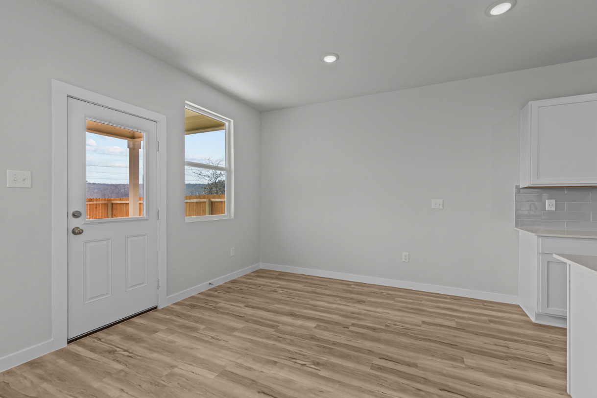 A room with a wood floor and a white door.