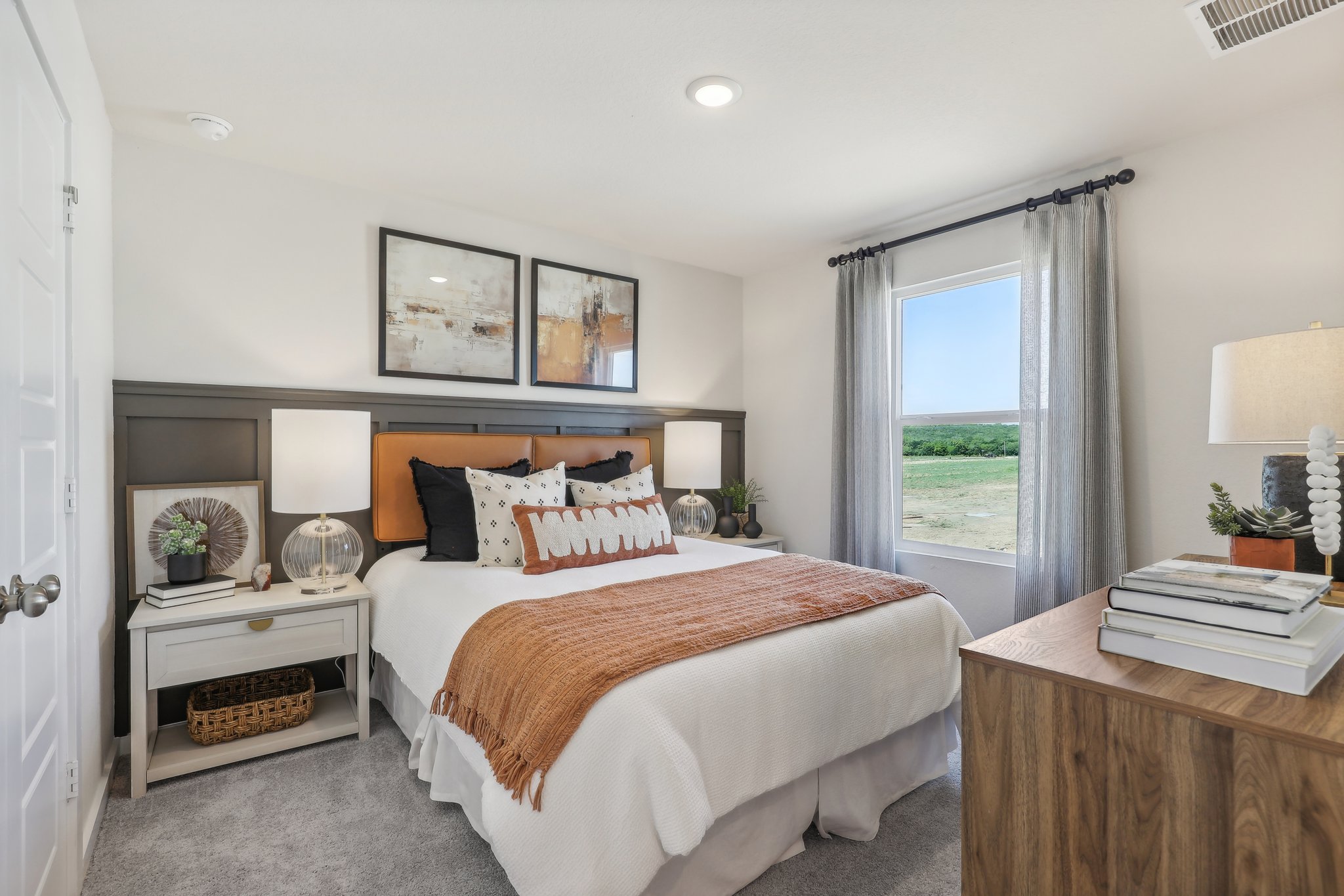 A bedroom with a bed and a table.