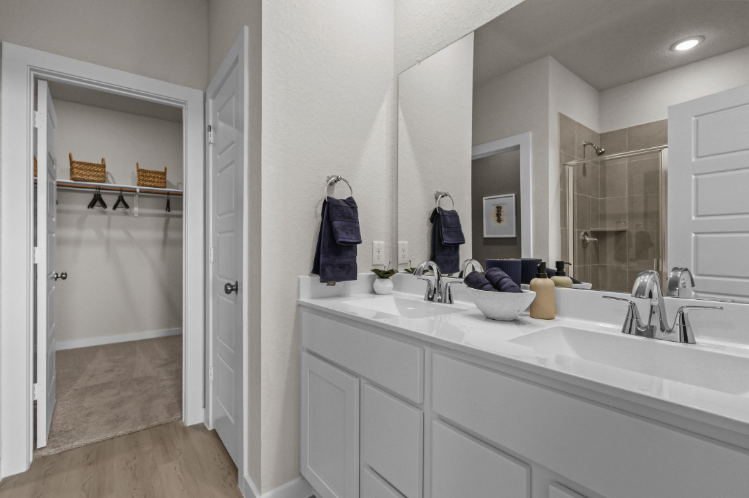 A bathroom with a large mirror.