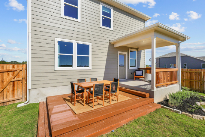 A house with a deck and chairs.
