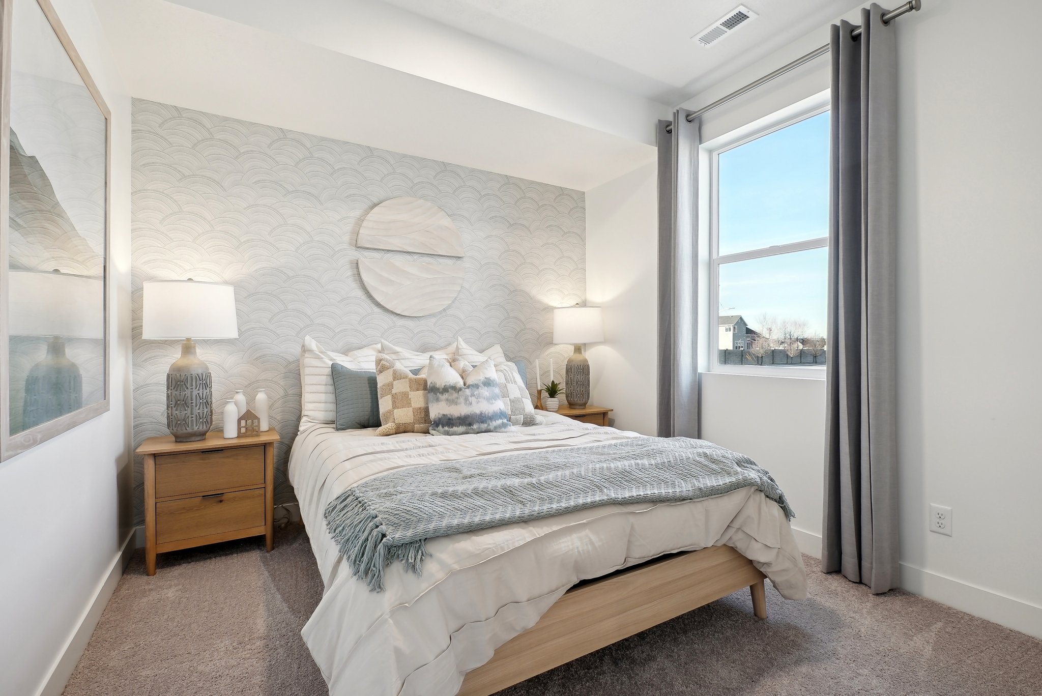 A bedroom with a large window.