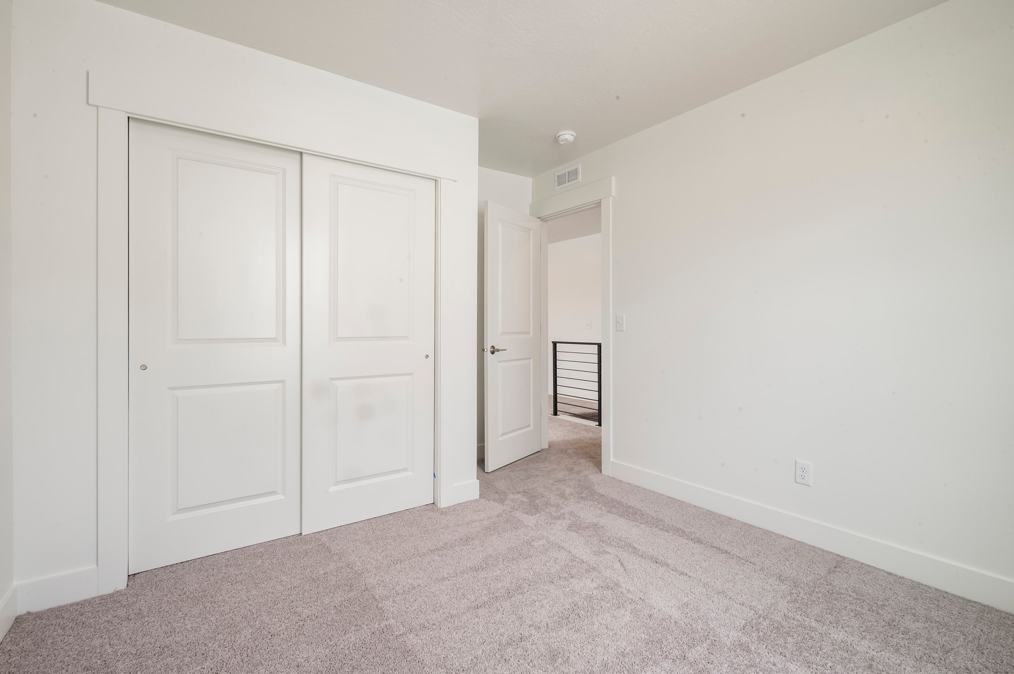 A hallway with white doors.