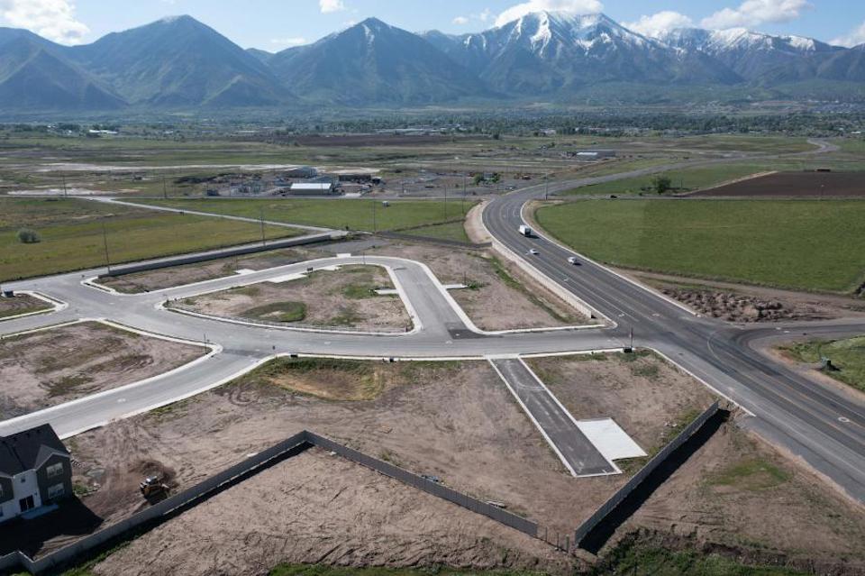 A road with a mountain in the background.