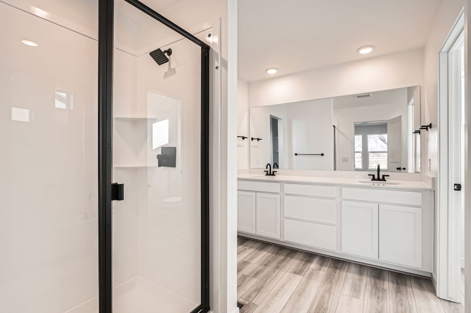 A bathroom with white cabinets.