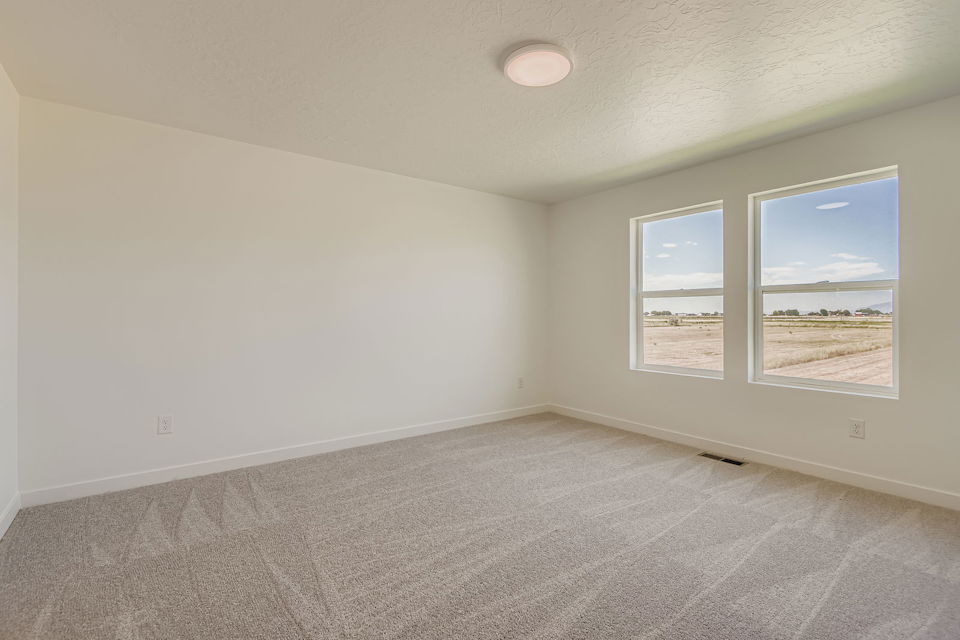 A room with a window and a carpet.