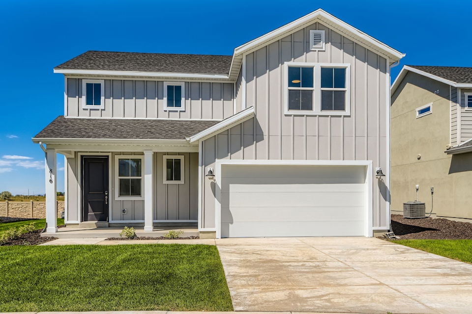 A white house with a garage.