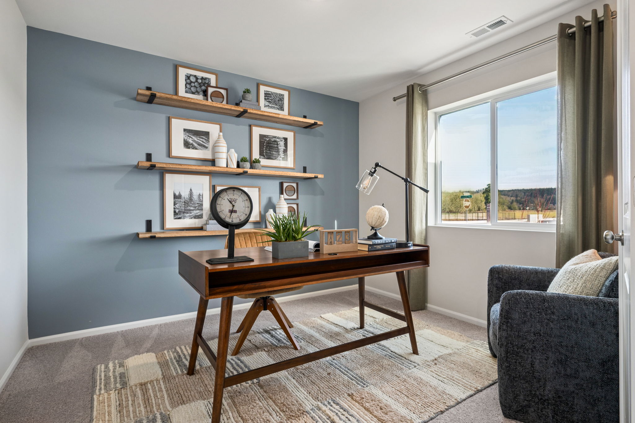 A living room with a table and a clock.