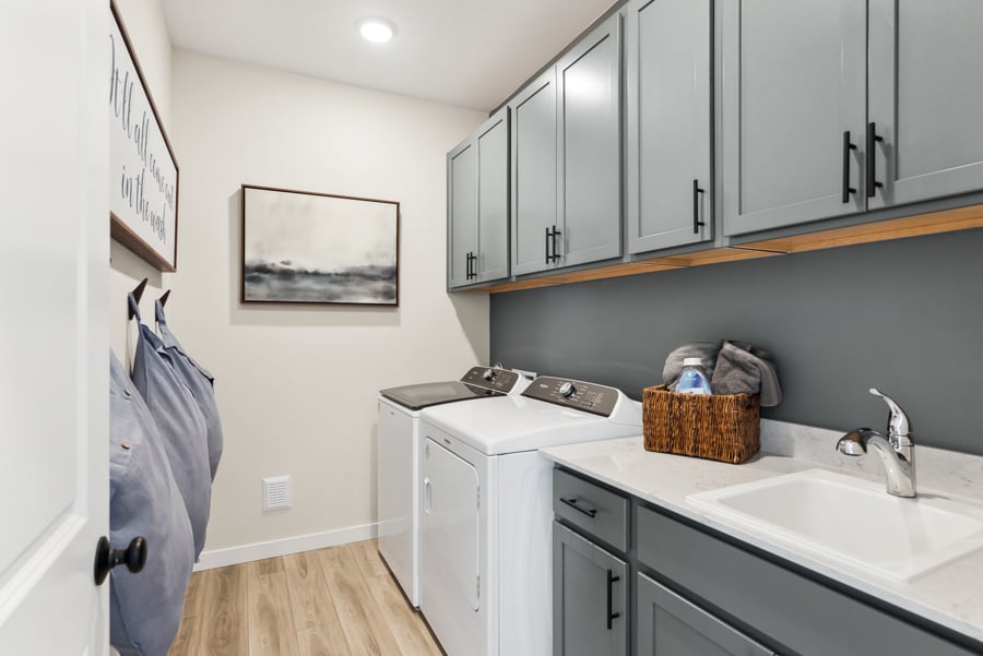 A kitchen with white cabinets.