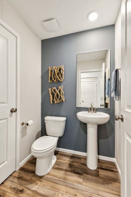 A bathroom with a toilet and sink.