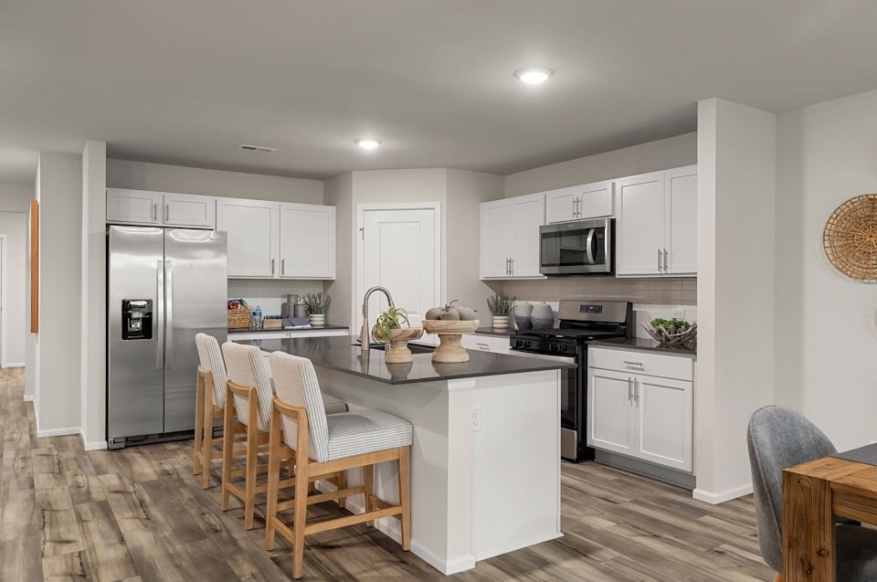 A kitchen with white cabinets.