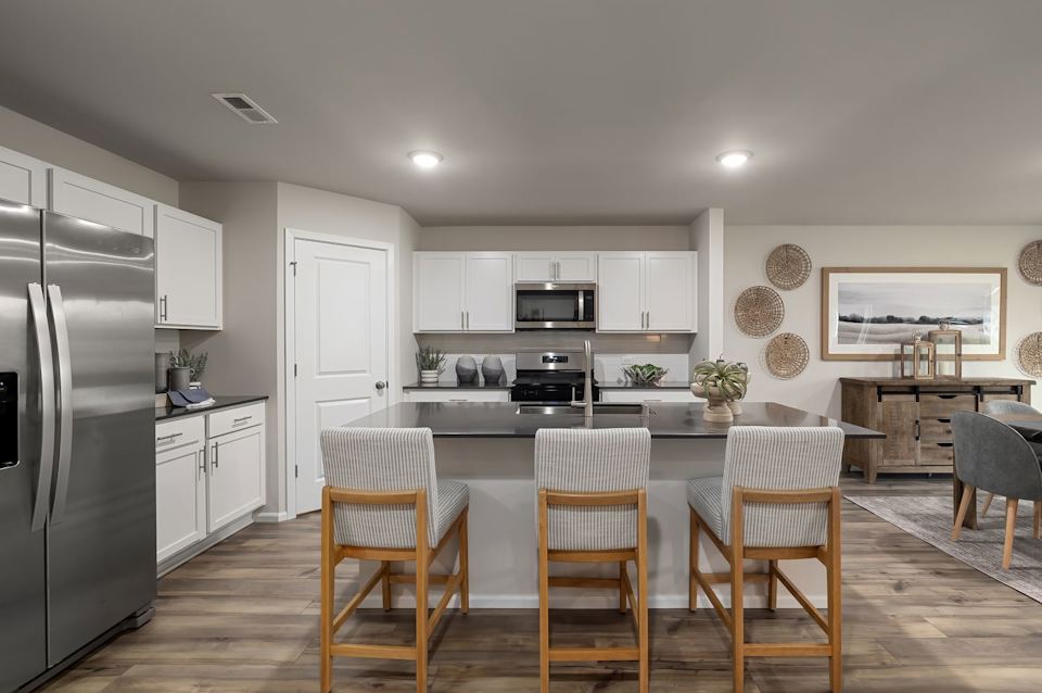 A kitchen with white cabinets.