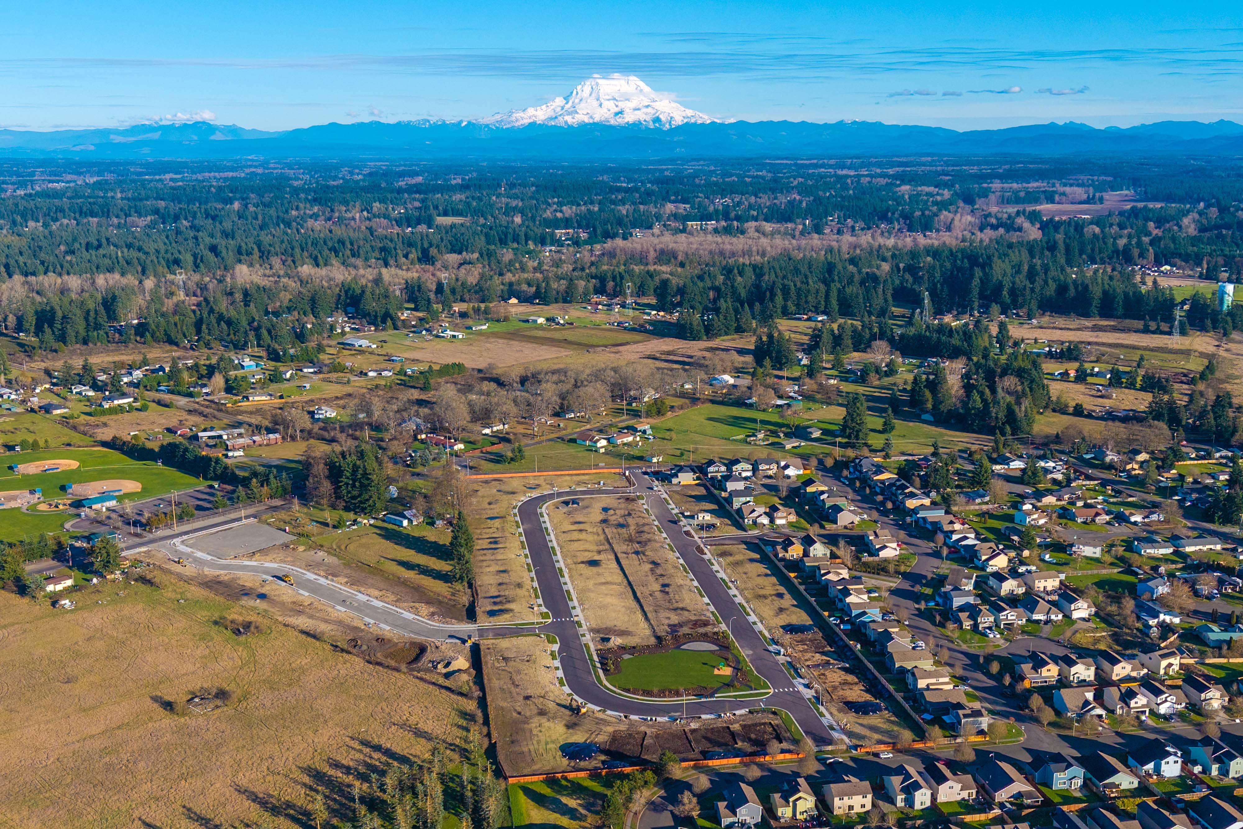 A large area with roads and a mountain in the background.