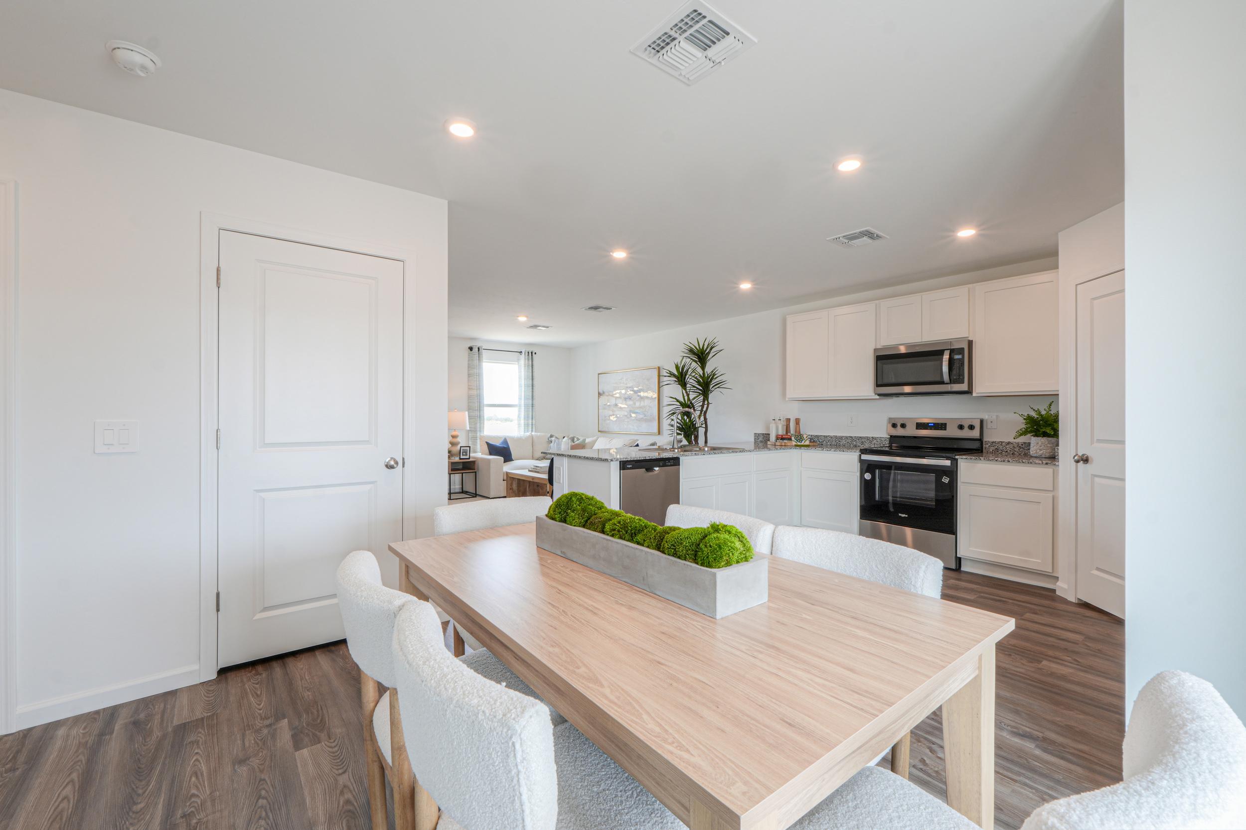 A kitchen with white cabinets.