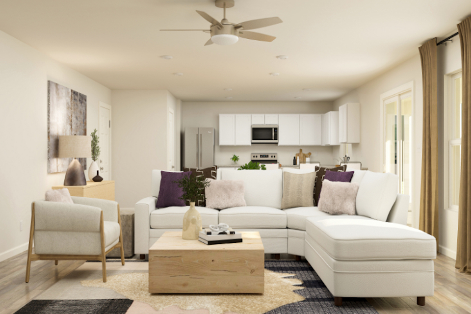 A living room with a white couch and a table.