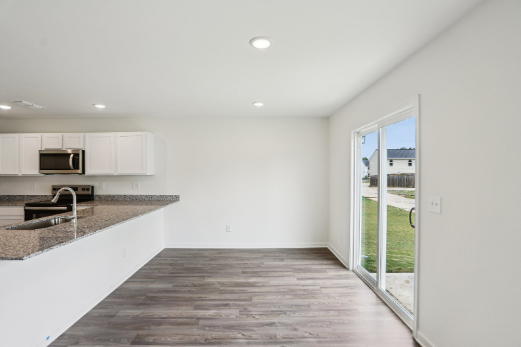 A kitchen with a large glass door.
