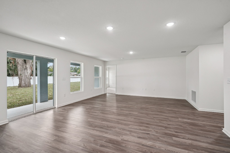 A room with white walls and a wood floor.
