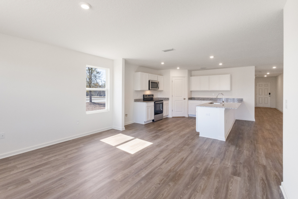 A large kitchen with white cabinets.