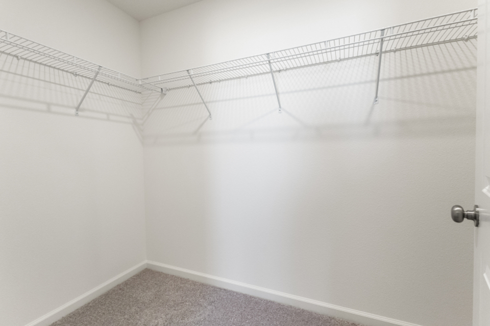 A white wall with a metal railing.