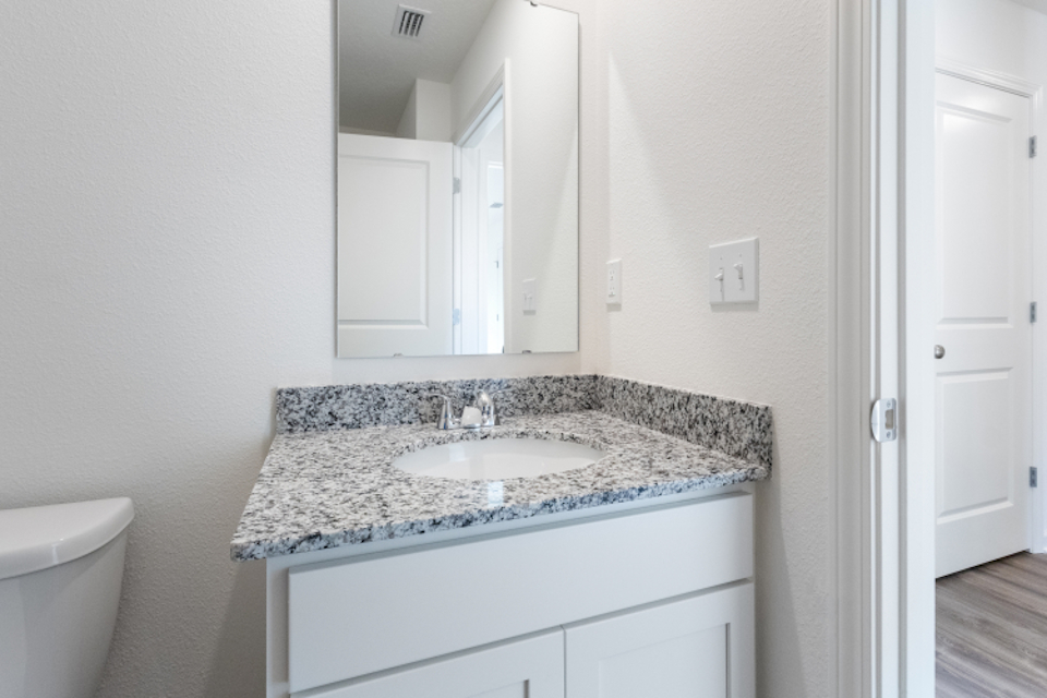 A bathroom with a marble countertop.