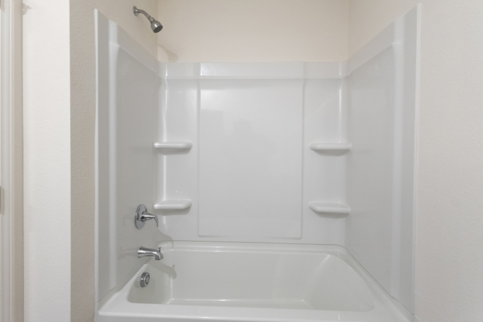 A bathtub and sink in a bathroom.