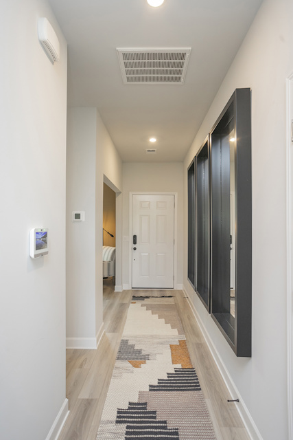 A hallway with a door and a window.