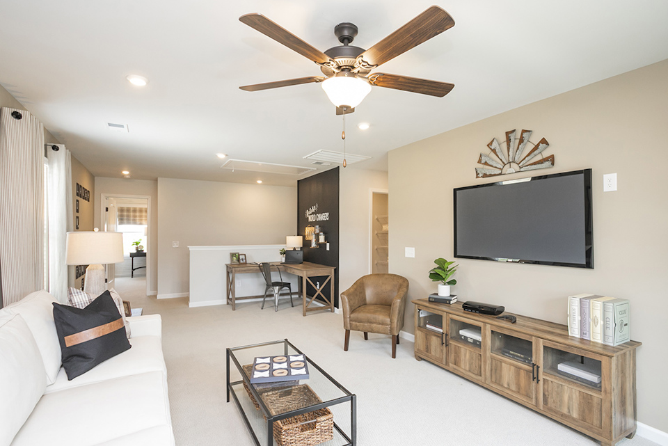 A living room with a tv and a table.