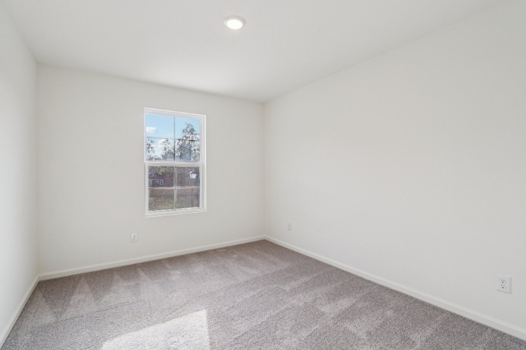 A room with a window and a tile floor.