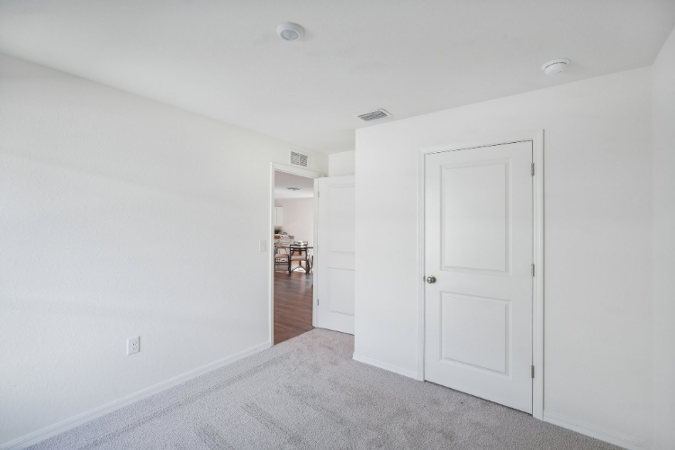 A hallway with white doors.