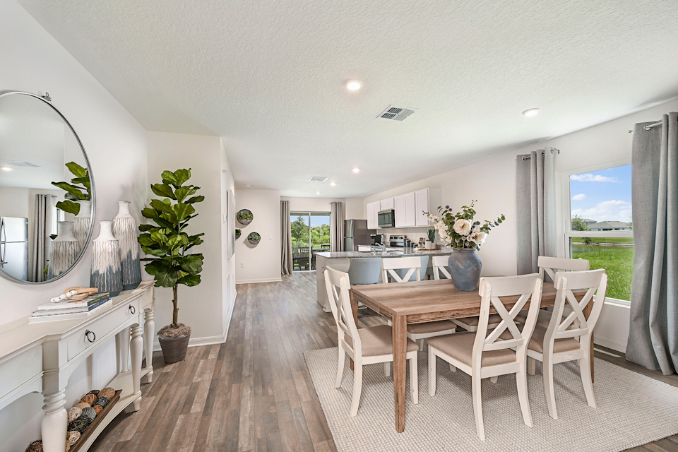 A dining room with a large table.