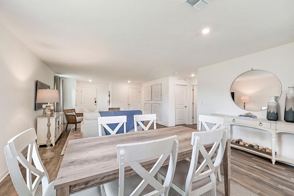 A dining room with white chairs.