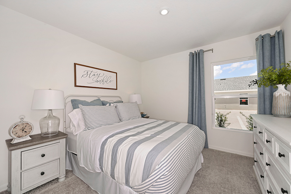 A bedroom with a bed and a window.