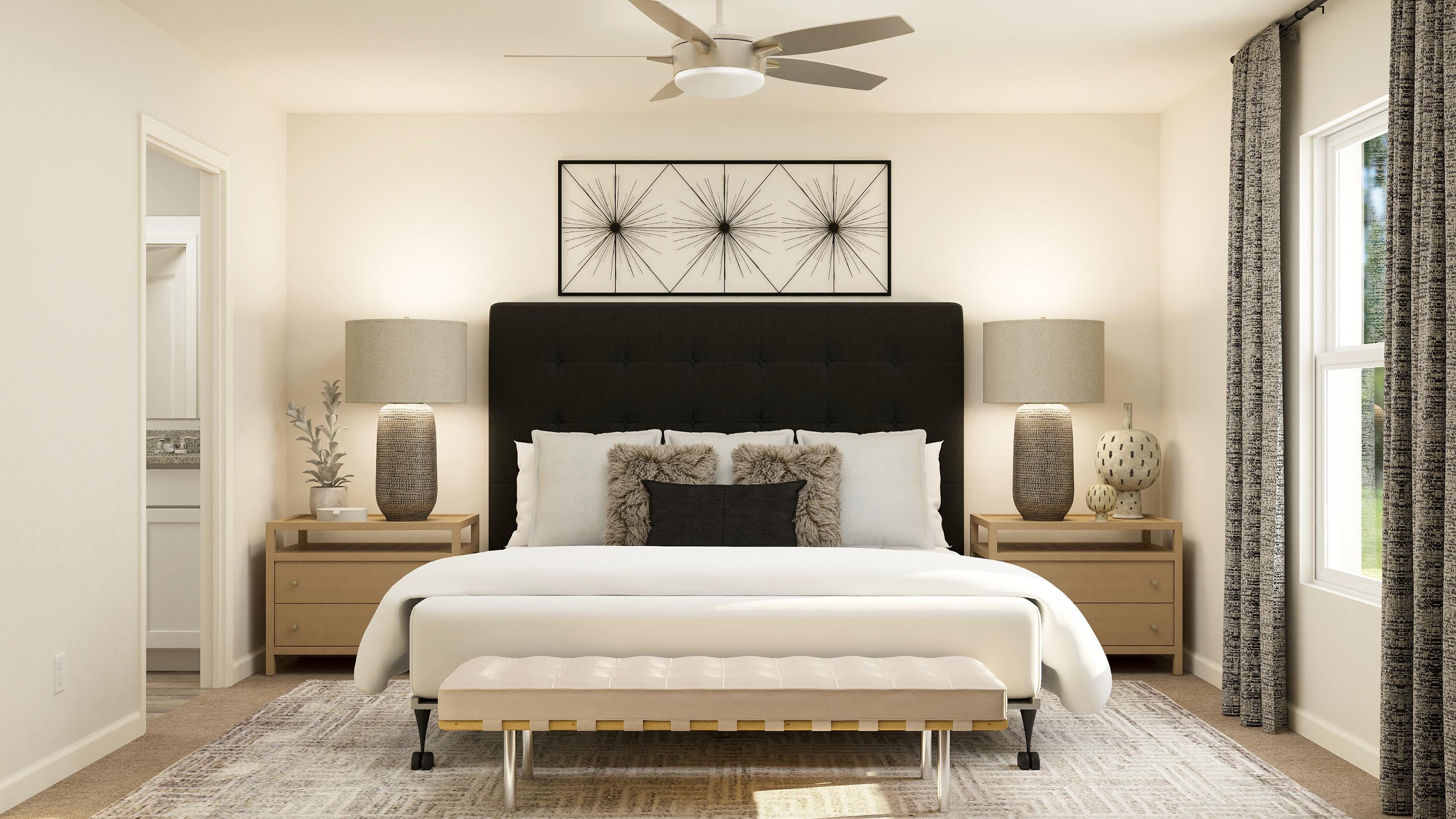 A bedroom with a bed and a fan.