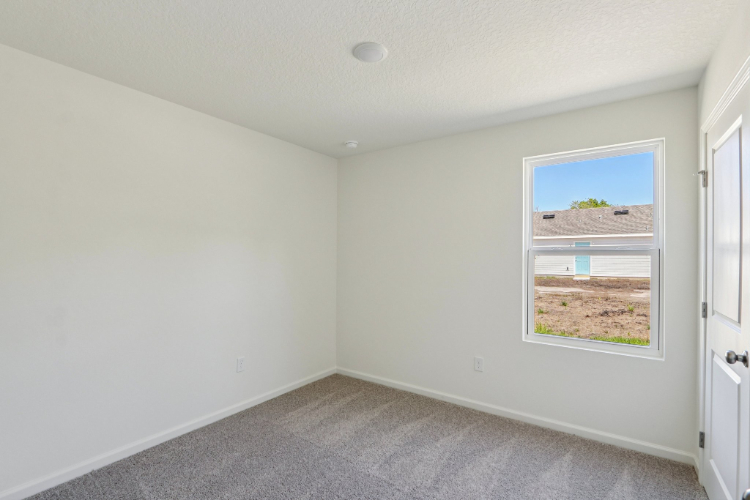 A room with a window and a door.