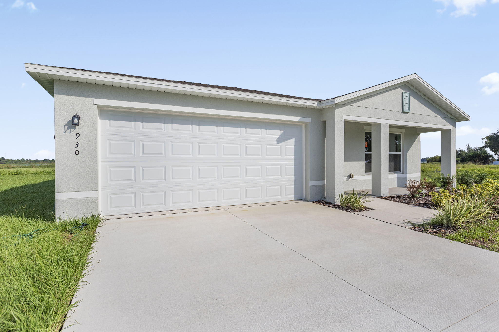 A white garage with a driveway.