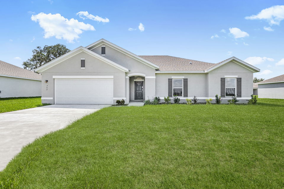 A house with a green lawn.